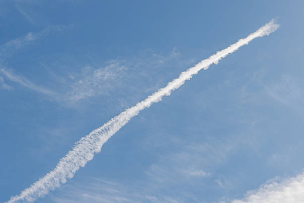 Blue sky and straight white contrails