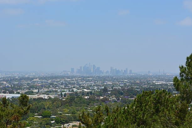 istock Distant View of a Bustling City Skyline Under a Bright Blue Sky Filled With Soft Clouds 2247059609