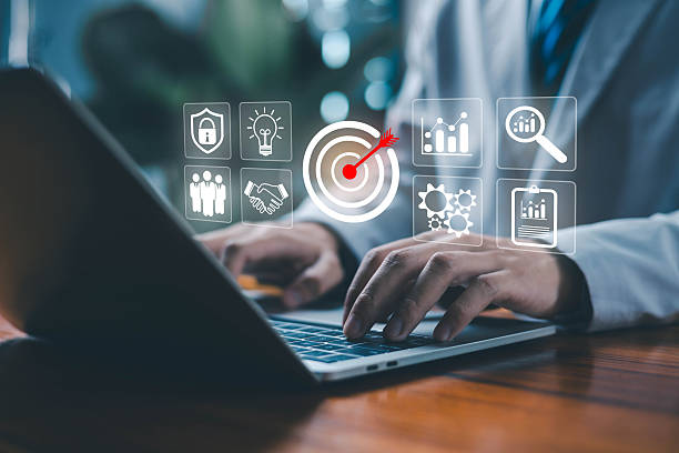 istock A business professional using a laptop with digital icons of target, analytics teamwork ideas, and security symbolizing strategic planning, KPI management, goal achievement, data analysis, and modern. 2247062393
