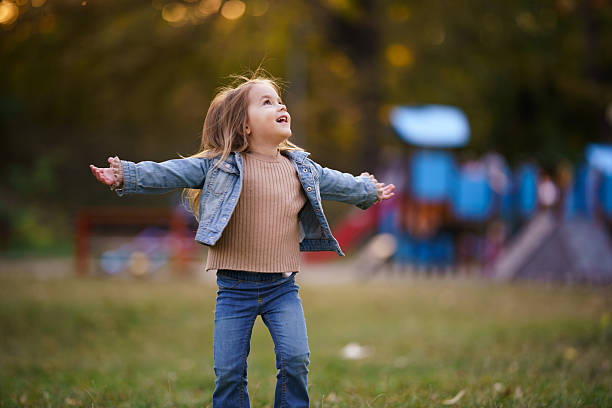Happy young girl enjoying freedom at a playground.