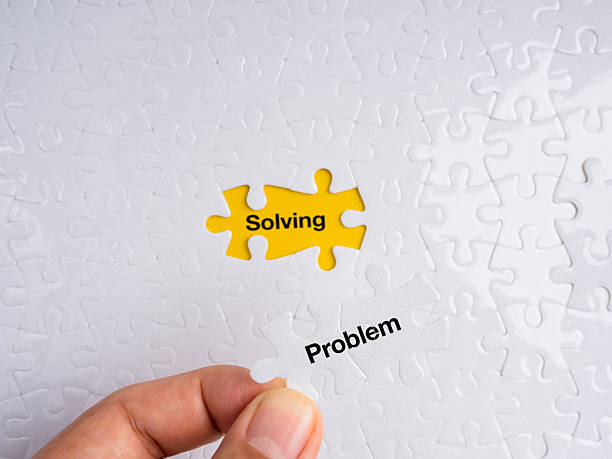 istock Hand placing a white puzzle piece labeled Problem into a yellow missing spot revealing the word Solving. Concept of problem-solving, strategy, logic, solution, and fixing issues. 2247066057