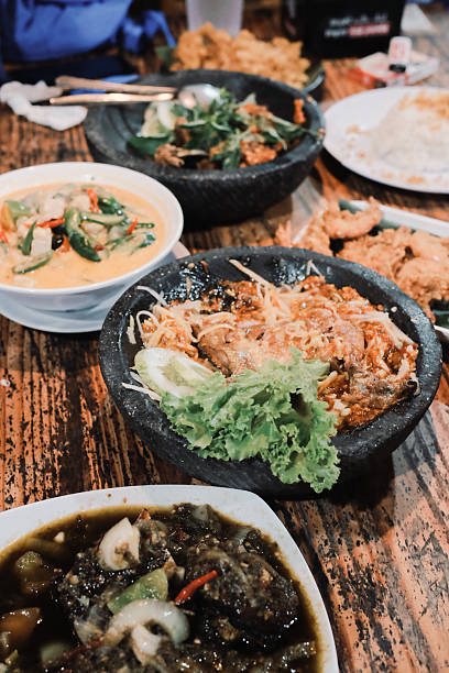 istock Delicious assorted Indonesian dishes served on wooden table creates an inviting atmosphere 2247073189