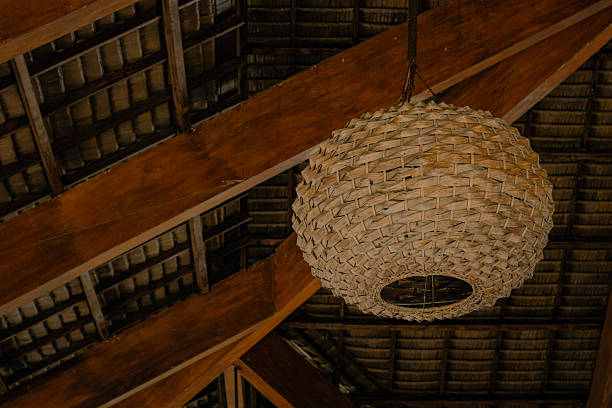 istock Woven rattan lamp against wooden beams 2247075251