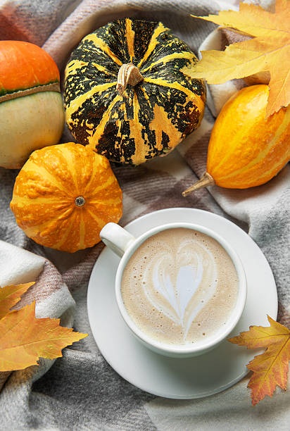 istock Warm coffee with latte art and autumn pumpkins 2247076243