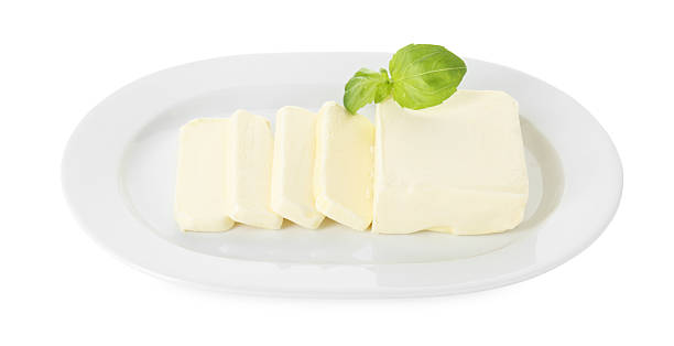 istock Dish with tasty cut butter isolated on white, above view 2247077594