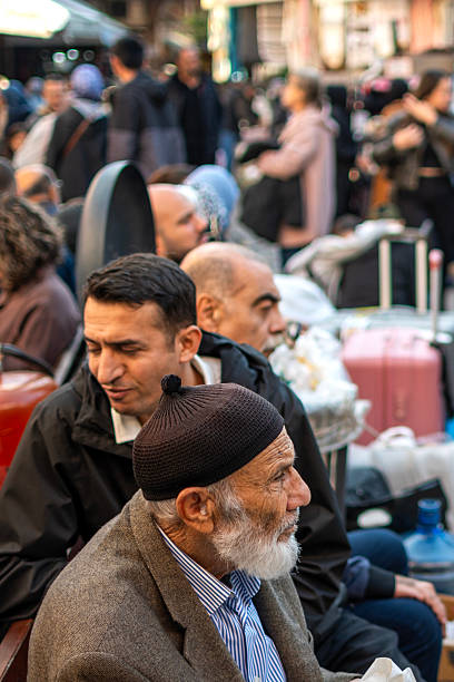 Istanbul, Turkey - November 13, 2025: People resting on Eminonu Square in Istanbul, Turkey