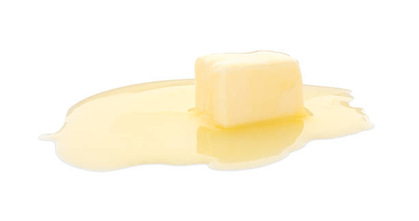 istock Piece of melting butter isolated on white 2247079574