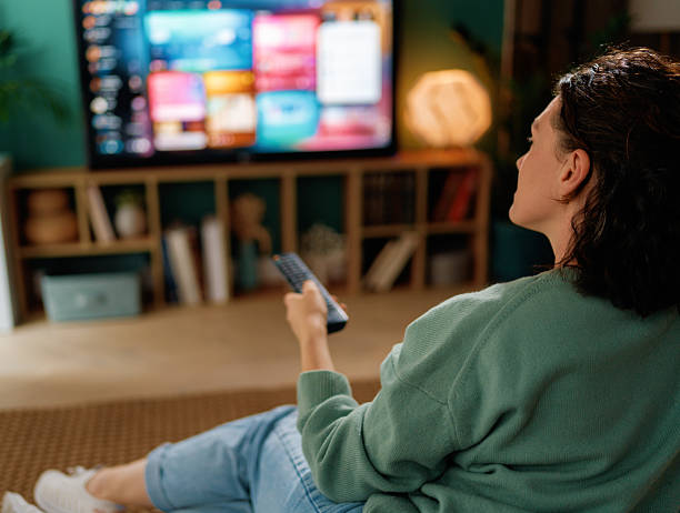 istock woman watching TV at home 2247079751