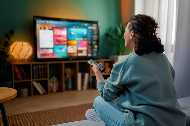 istock woman watching TV at home 2247079765