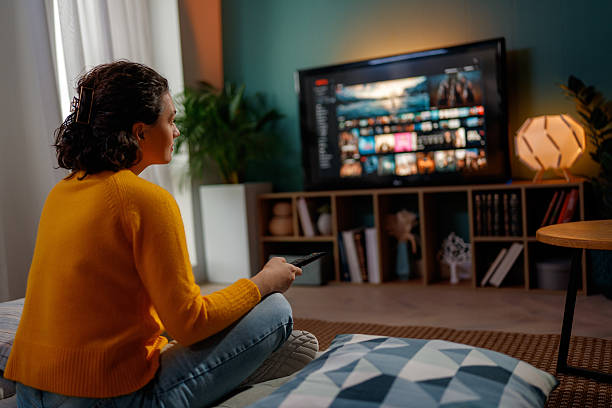 istock woman watching TV at home 2247079776