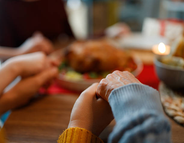 istock Family holding hands in prayer 2247081333