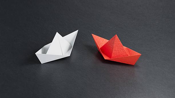 istock Different business concept.new ideas. paper art style. creative idea.Red and white paper boat. Leadership concept.3D rendering on black background. 2247082607