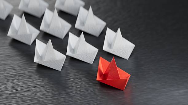 istock Different business concept.new ideas. paper art style. creative idea.Leadership concept, black leader boat leading white boats.3D rendering on black background. 2247082620
