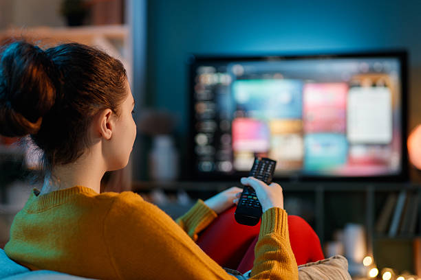 istock woman watching TV at home 2247084109