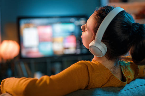 istock woman watching TV at home 2247084119