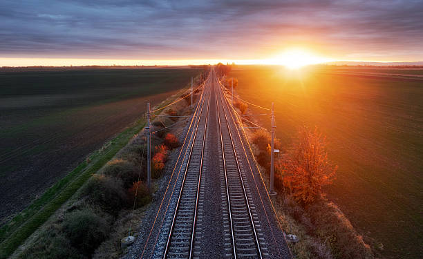 istock The railway through the autumn forest at dawn. Drone view 2247085342