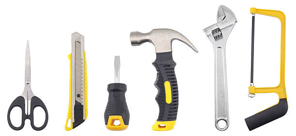 istock A set of essential hand tools including scissors, a utility knife, screwdriver, hammer, adjustable wrench, and hacksaw displayed on a white background, representing repair work, construction, DIY 2247087216
