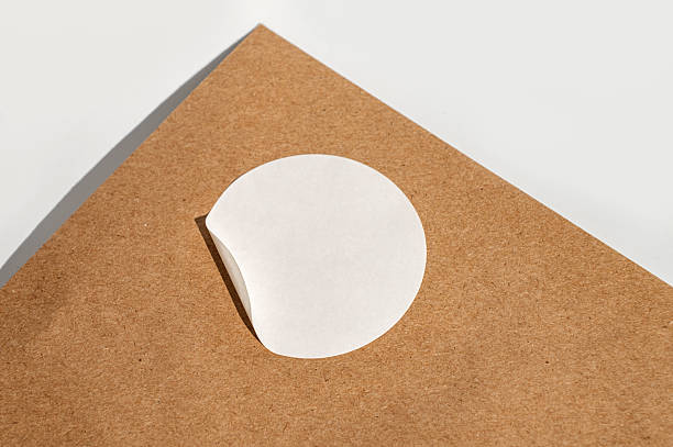 istock Brown paper with round white sticker on minimalist background 2247087522