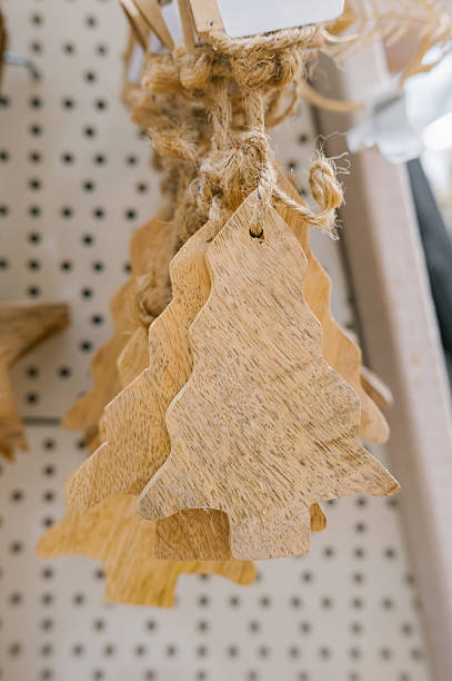 istock Rustic wooden christmas tree ornaments on display at market 2247087608