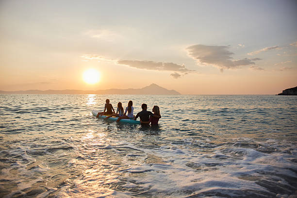 Family enjoying vacation together during bright sunset at sea