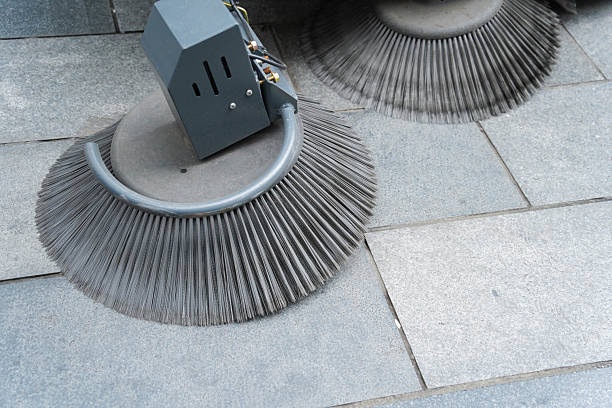 istock Special street cleaning machine with rotating broom sweeping the road. 2247088638