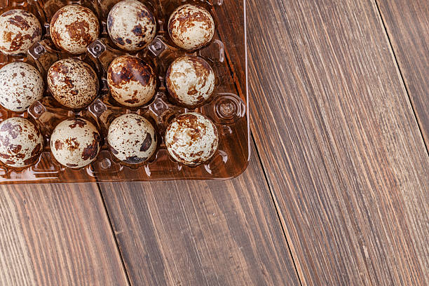 istock Group of quail eggs are put on clear tray on wooden table 2247088729
