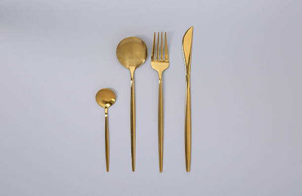 istock Stylish golden cutlery set on gray background, flat lay 2247090428
