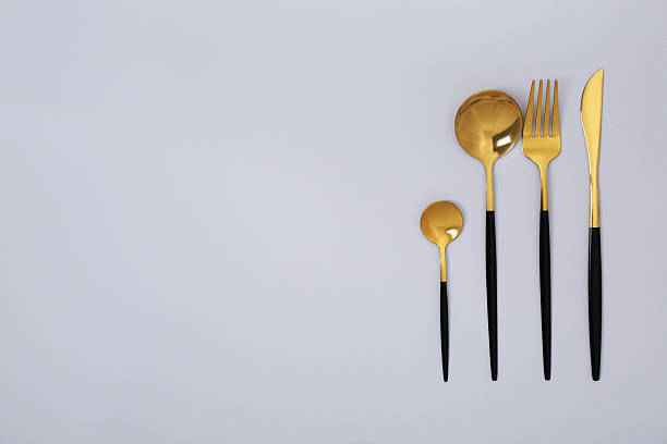 istock Stylish golden cutlery set on gray background, flat lay. Space for text 2247090442