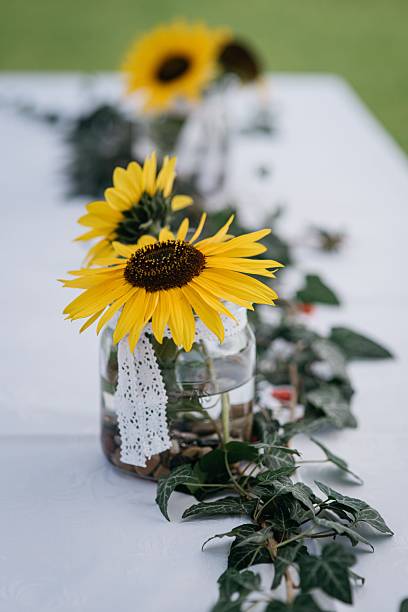 istock Sunflowers and a lace centerpiece on a white table. 2247090824