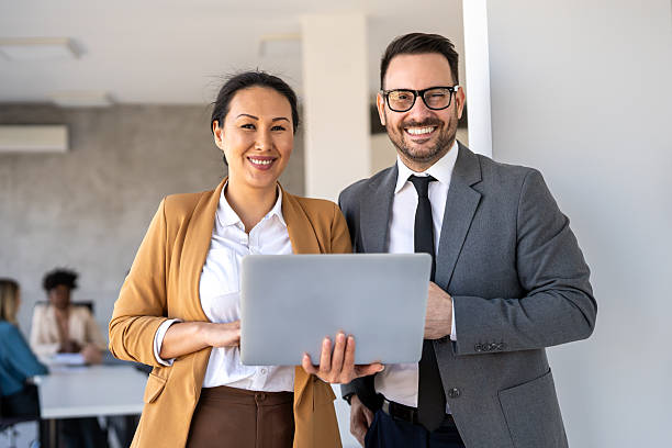 istock Happy multiethnic businesspeople laughing while collaborating on a new project in an office. 2247091623