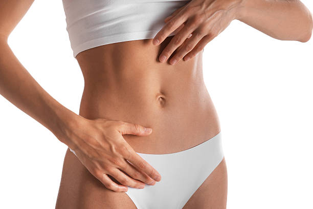 istock Woman with flat belly on white background, closeup 2247093960