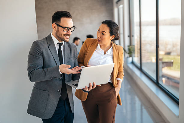 istock Two happy diverse multiethnic business team people working, talking in corporate office 2247095309