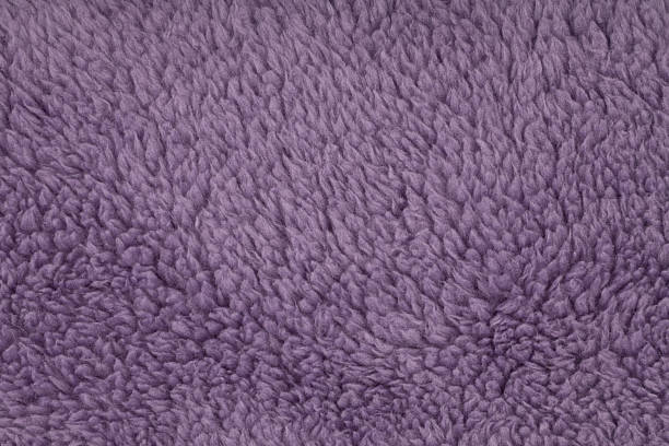 Detailed close up view of soft dusty purple sherpa fleece textile providing a vibrant abstract background texture