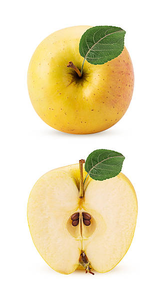 istock Golden apple delicious whole one cut in half with green leaf 2247096515