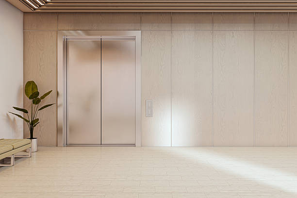 istock Modern corporate lift entrance with clean wood panel wall and blank space for signage or logo mockup in bright office interior. 3D Rendering 2247096708