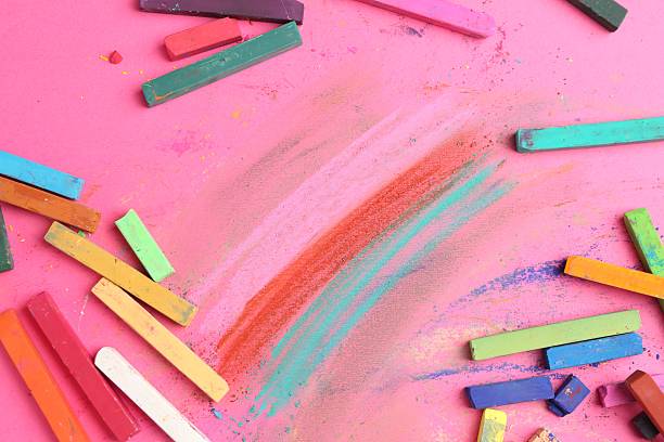 istock Many colorful chalk pastels on pink background, flat lay 2247096764