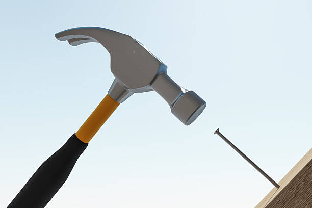 A silhouette of a hammer suspended in mid-air. The image is full of mystery and intrigue, and it would make a great addition to any home or office. Perfect for projects related to construction, industry, or even abstract concepts.