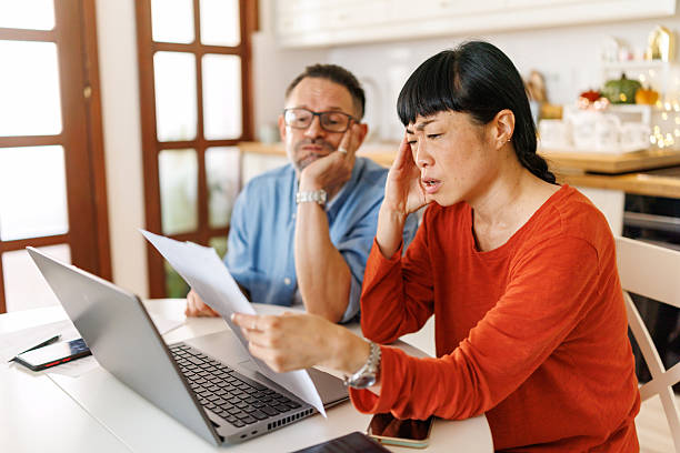 istock Frustrated couple checking financial statements at home using laptop 2247097297