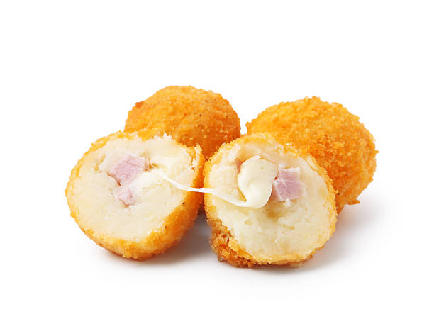 istock Delicious fried croquettes with cheese and ham isolated on white 2247097437