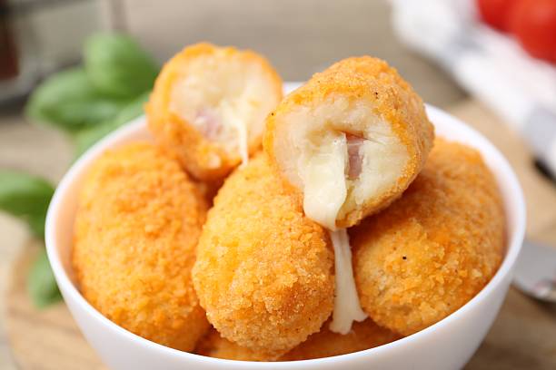 istock Delicious fried croquettes in bowl on table, closeup 2247097451