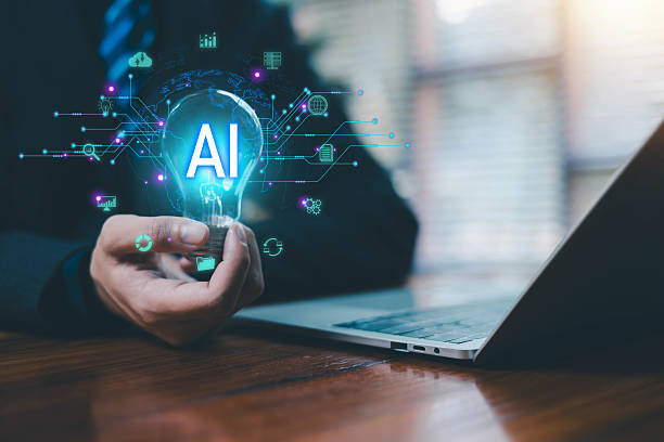 istock Businessman holding a glowing light bulb with AI text and futuristic digital circuits, symbolizing artificial intelligence innovation smart technology machine learning, creative ideas, data solutions. 2247098396