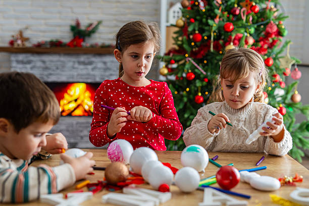 istock Children Enjoying a Christmas Ornament Craft Session 2247098480