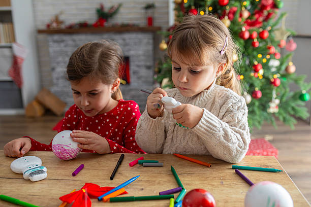 istock Kids Decorating Handmade Holiday Ornaments 2247098517