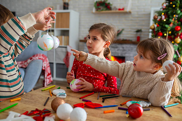 istock Children Enjoying a Christmas Ornament Craft Session 2247098593