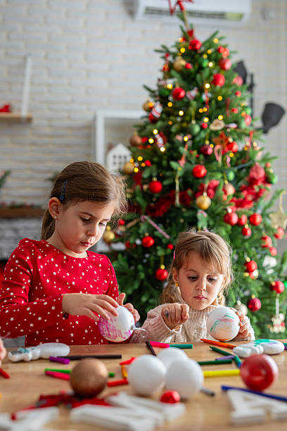 istock Kids Decorating Handmade Holiday Ornaments 2247098705