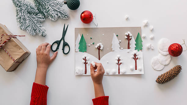 istock Child's handmade winter forest Christmas card with decorations on white background 2247098729
