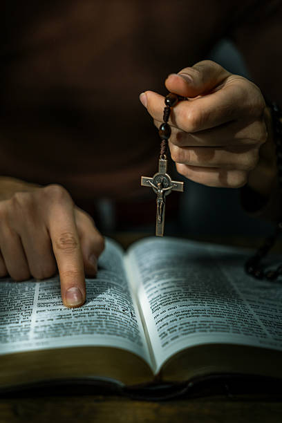 istock Woman Praying with Rosary 2247099562