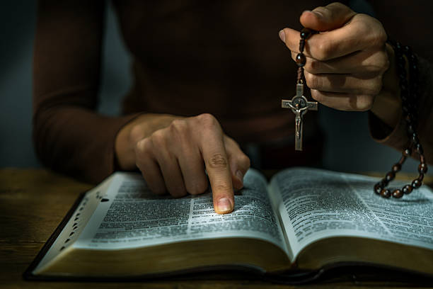 istock Woman Praying with Rosary 2247099573