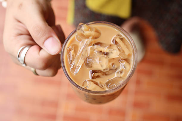 istock Close up of iced coffee on hand 2247102316