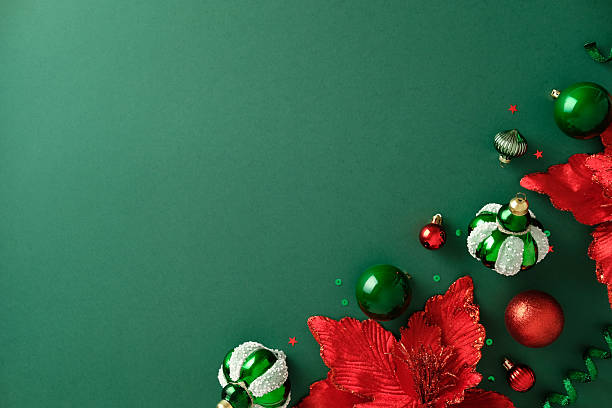 istock Christmas corner border: ornaments, poinsettia on deep green background. 2247103498